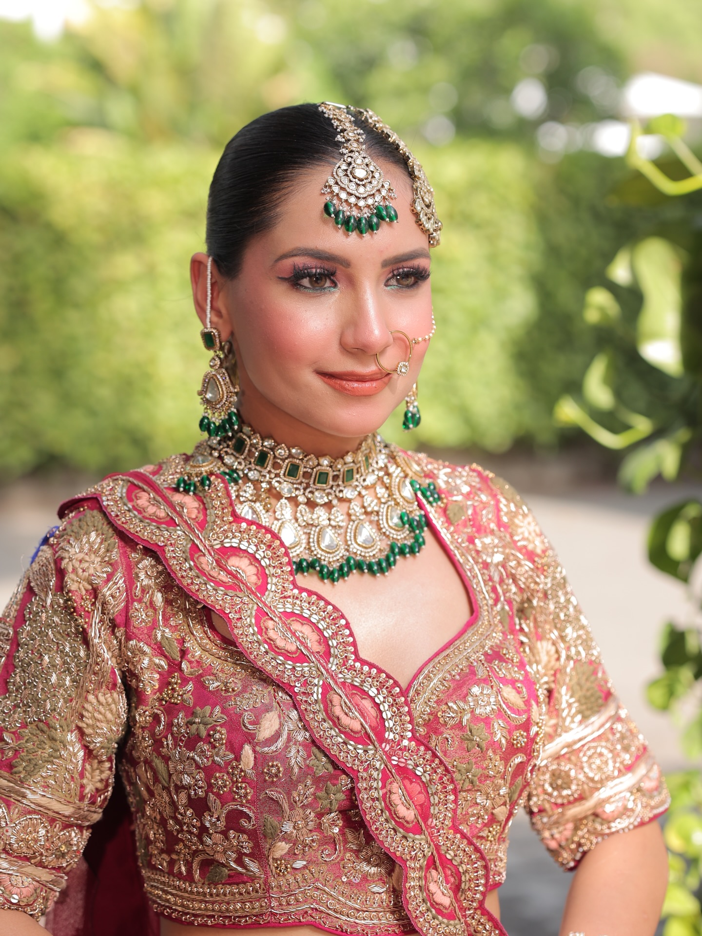 Bride in maroon lehenga with contemporary glam makeup